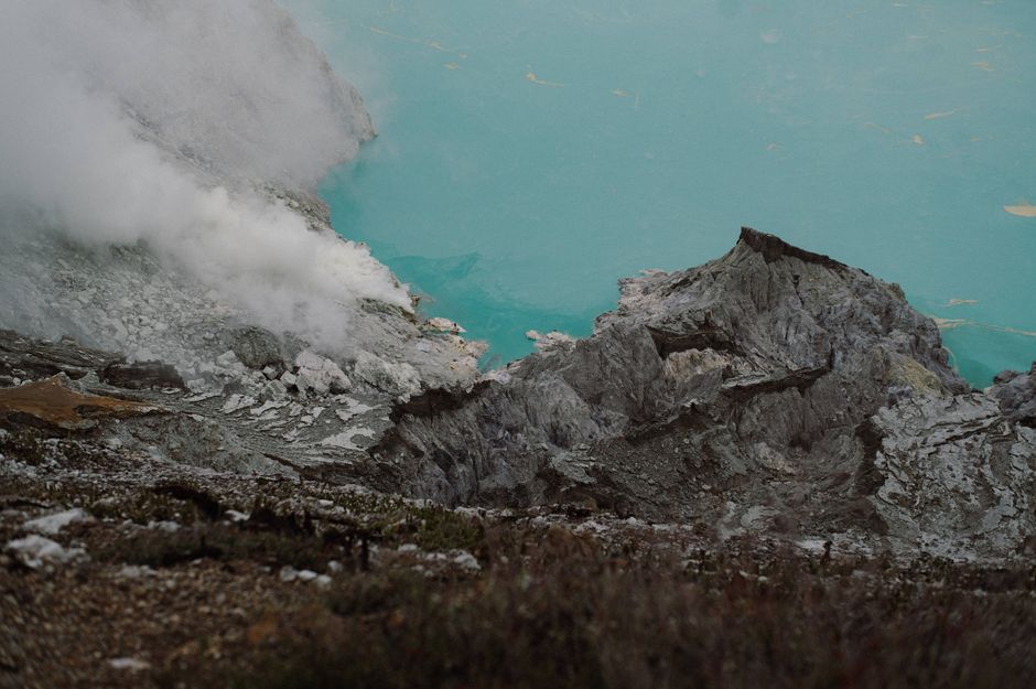 A stunning view of the Ijen volcano crater lake with steaming sulfur vents in East Java, Indonesia.