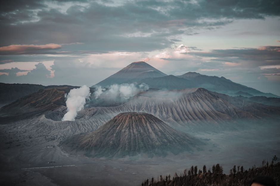 Stunning sunrise landscape featuring Mount Bromo and surrounding mountains in Indonesia.